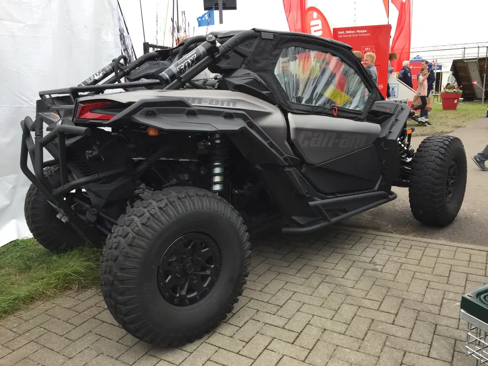 Gray Can-Am Maverick X3 side-by-side parked outdoors